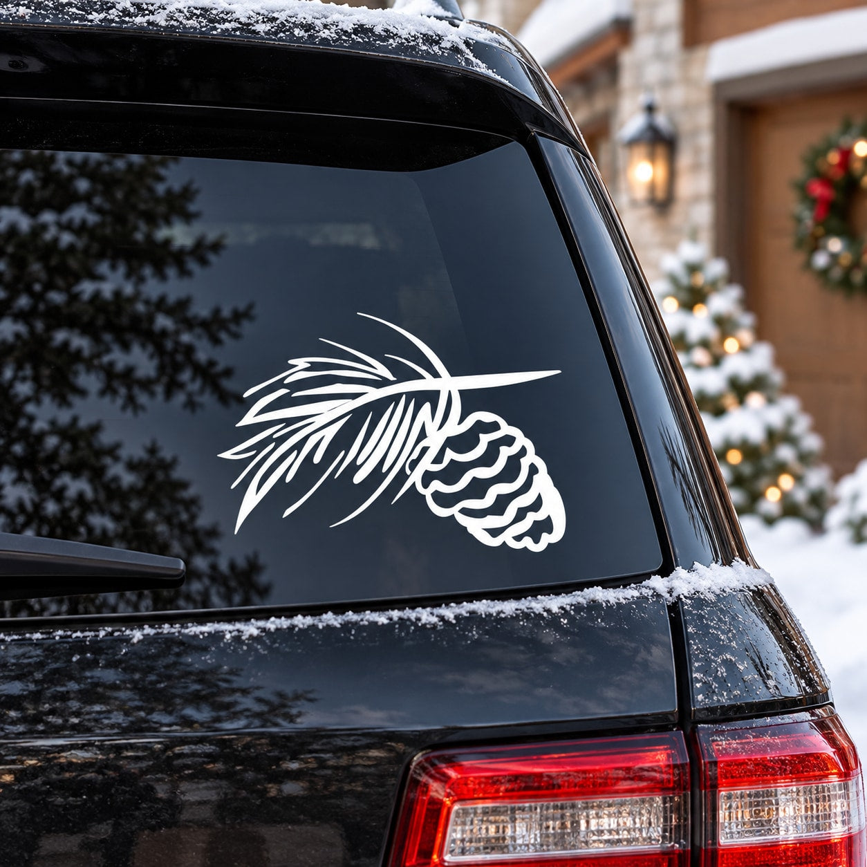 White pinecone and fir branch decal on car rear window