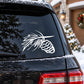 White pinecone and fir branch decal on car rear window