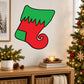 Cartoon stocking sticker in green and red with black outline and curled cuff