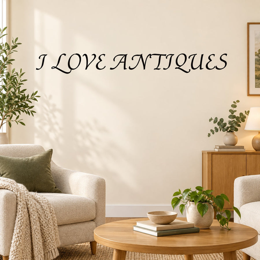 Black lettering wall decal reading “I LOVE ANTIQUES” in ornate script.