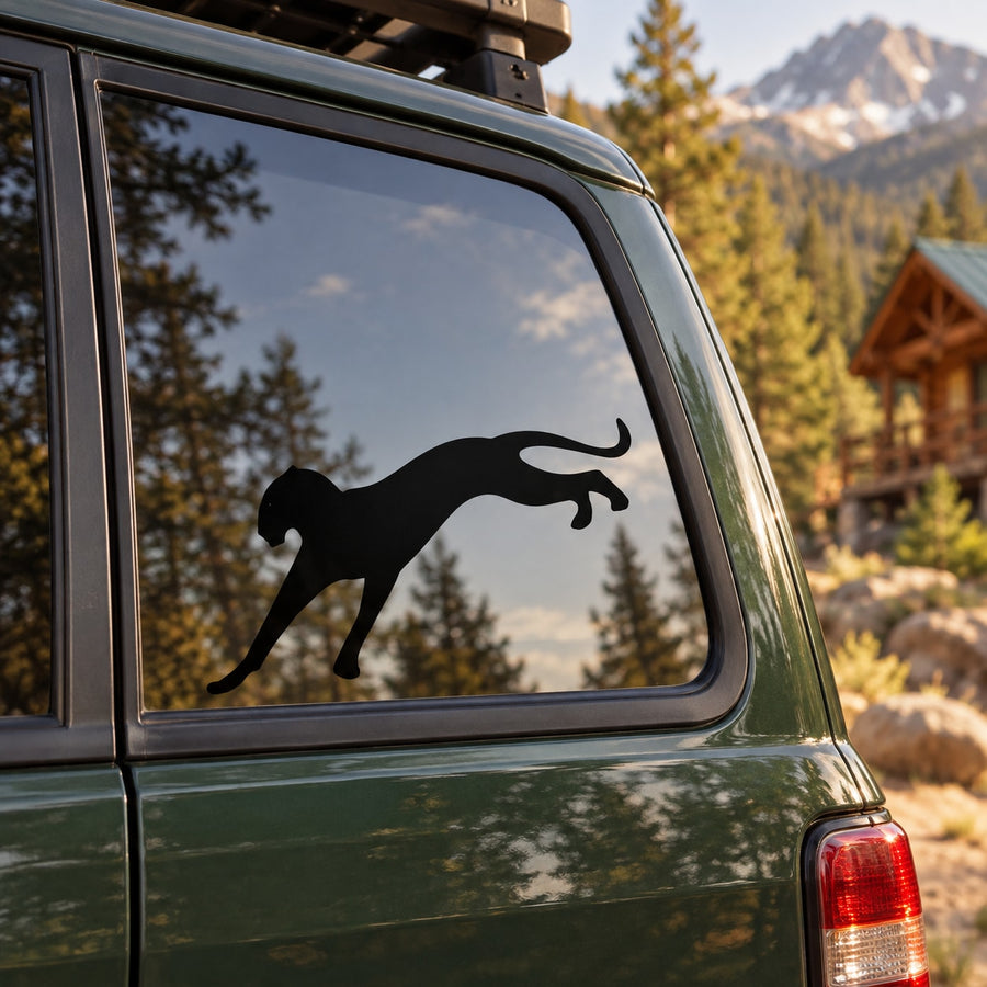 Black cougar hopping window decal on dark car door panel
