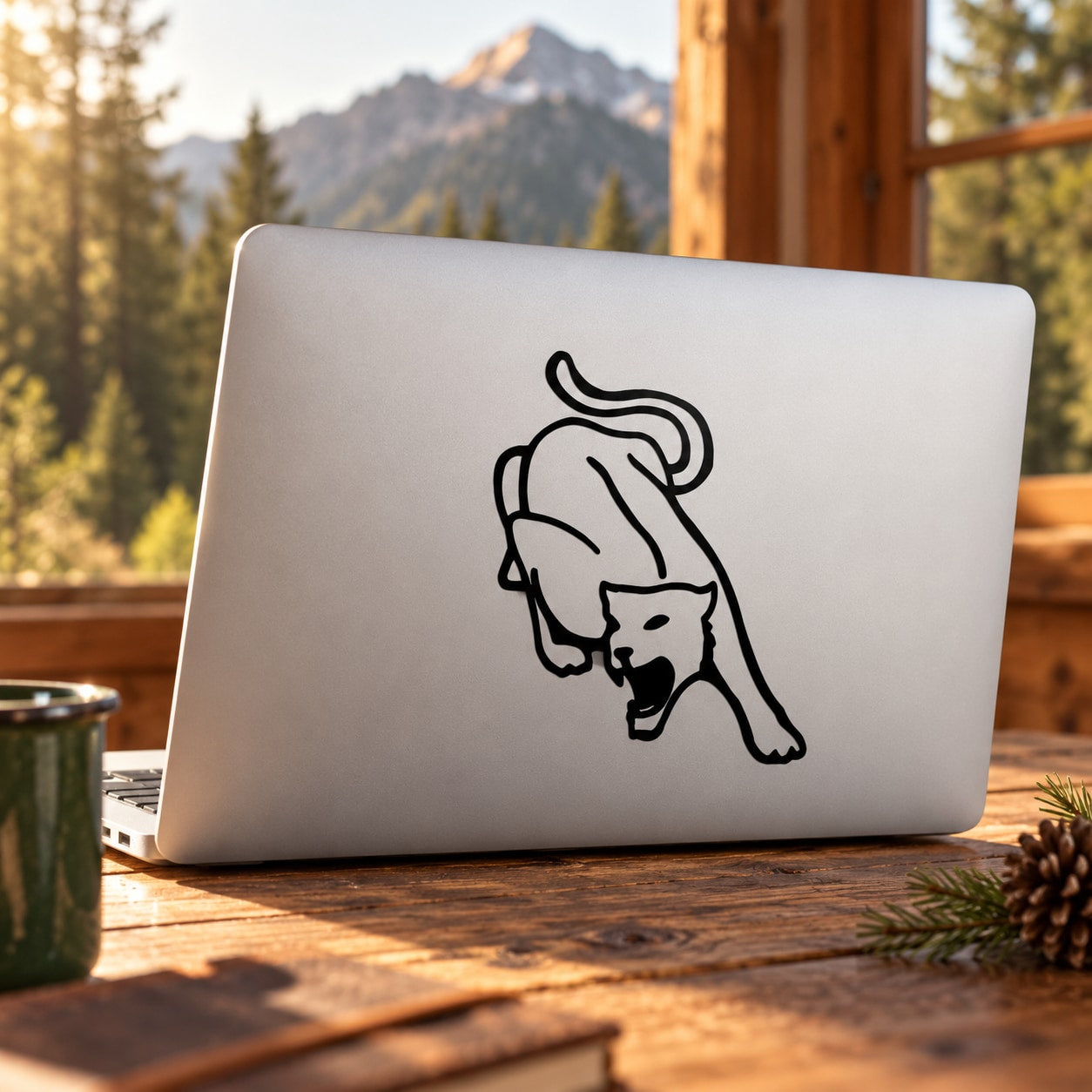 White laptop with black cougar turning pose line-art decal