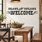 Inlaws and Outlaws Welcome — illustrative vinyl decal application mockup. Surrounding objects are not included.