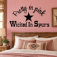 Pretty in Pink Wicked in Spurs Wall Decal — illustrative vinyl decal application mockup. Surrounding objects are not included.