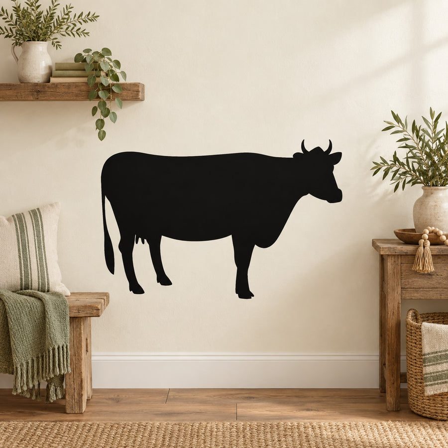 Black cow wall decal silhouette with visible legs and tail
