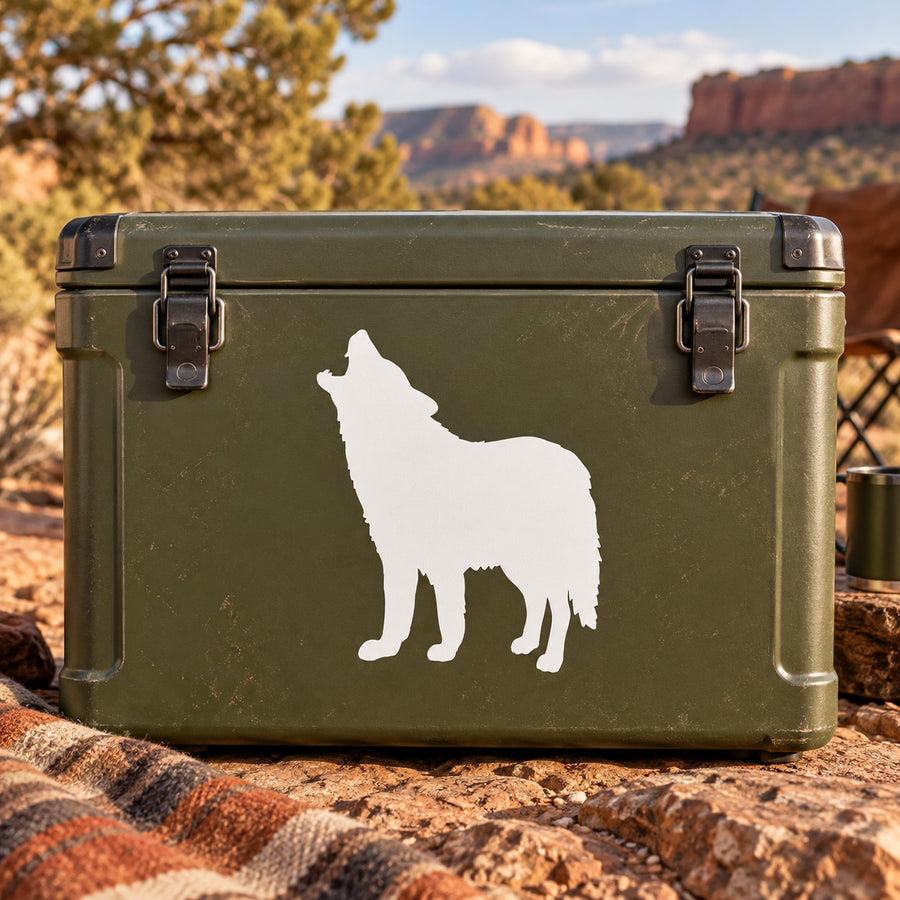 White coyote howling up decal silhouette on a green surface