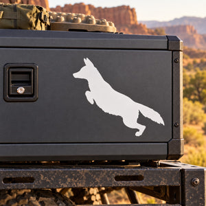 Leaping coyote decal sticker with white silhouette on dark surface