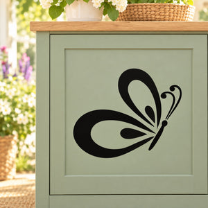 Butterfly decal: black swirled butterfly design on a light panel
