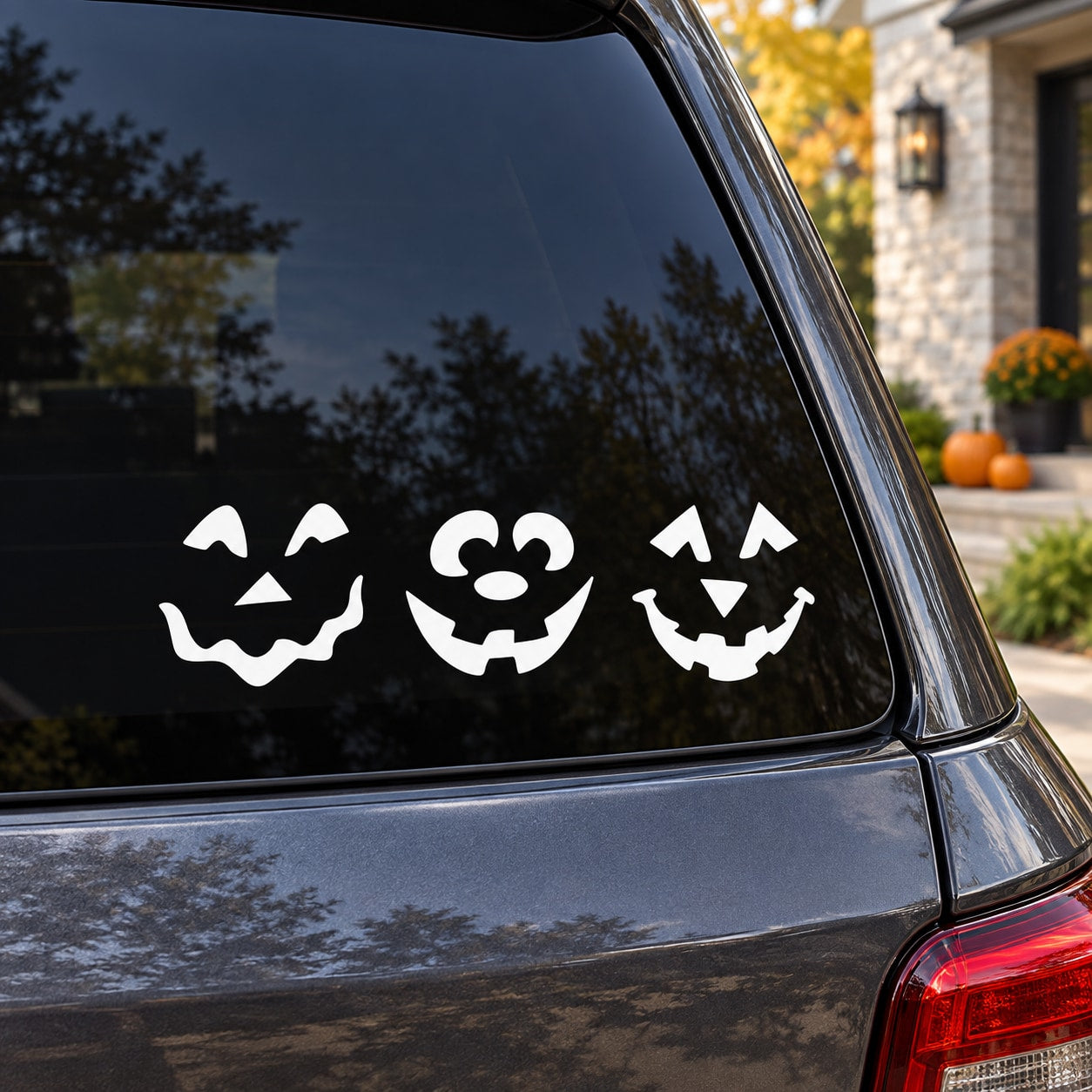 Halloween pumpkin face vinyl window decal set with three jack-o-lantern faces