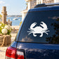 White ocean crab decal on dark blue car window