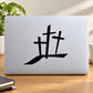 Triple cross decal with black symbol on light surface