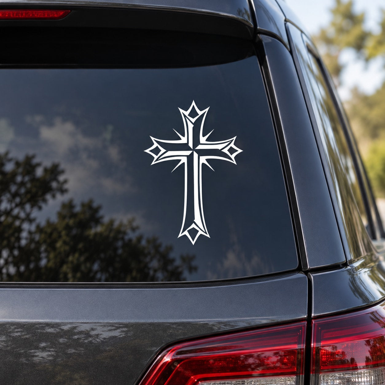 Pointed cross decal with detailed linework, white outline on dark surface