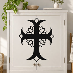 Black cross decal with layered flower petals, centered on a white cabinet door