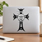 Black cross and sun face decal with stylized figure on a light device lid