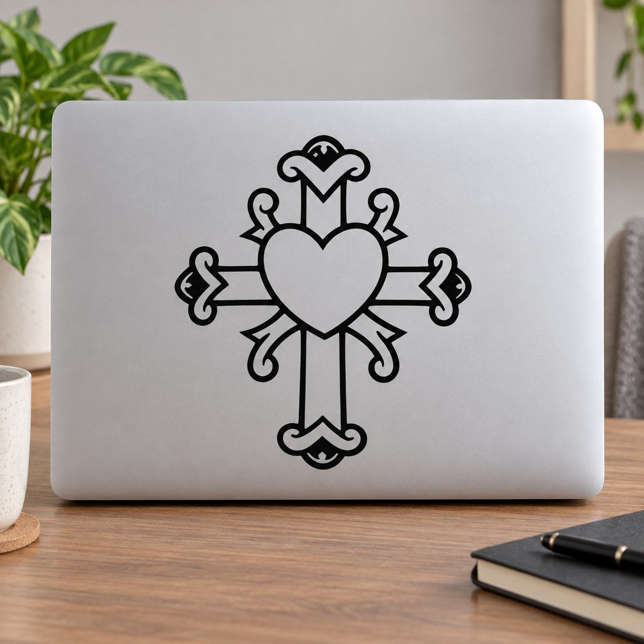 Decorative cross decal with center heart, black outline on light surface