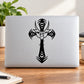 Laptop with black demon mask cross decal graphic