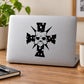 Light gray laptop with black demon mask cross decal