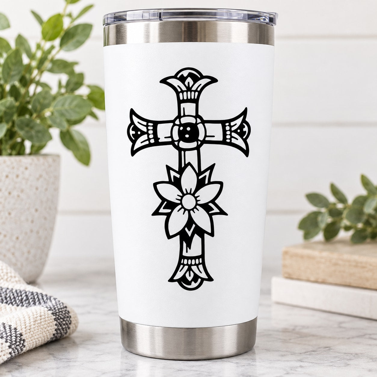 Insulated stainless steel tumbler with black cross and flower decal on white