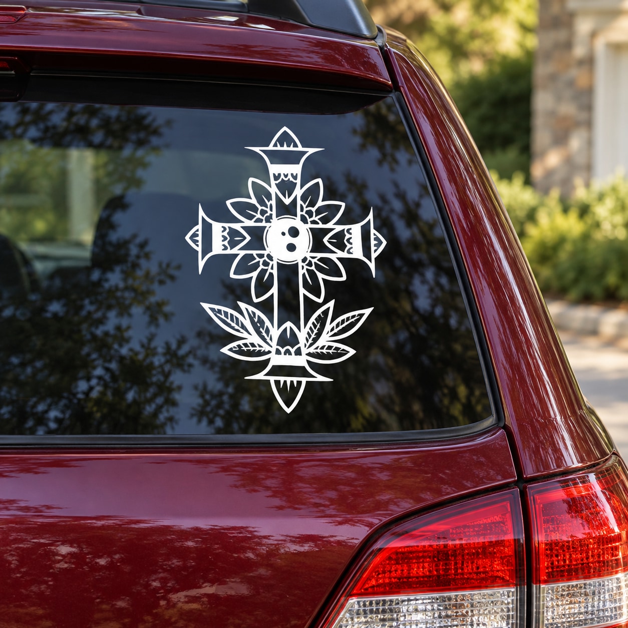 Decorative flower cross decal: white floral cross with leaf accents on car window