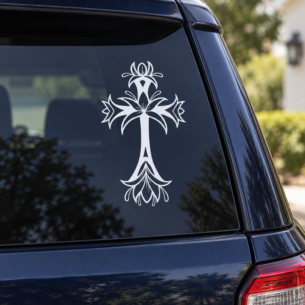 White blooming cross decal with ornate floral details on car window
