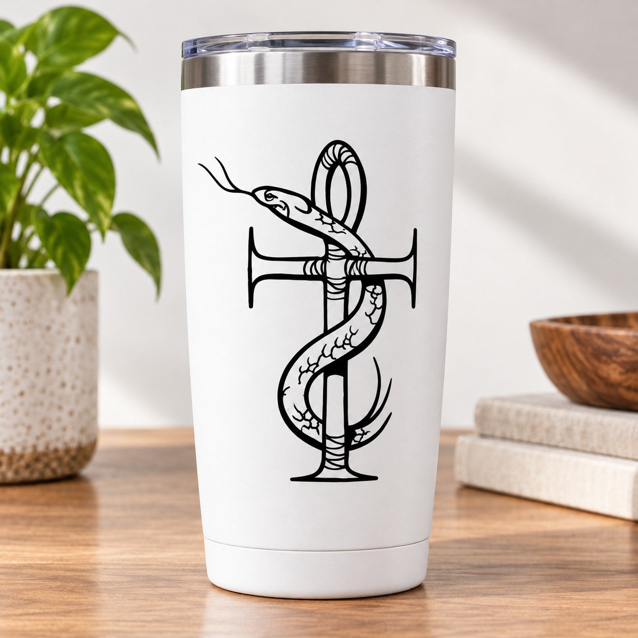 White tumbler with metal lid and black ankh-and-snake decal