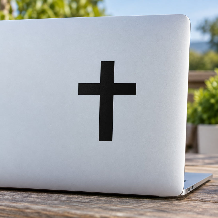 Black cross decal on light laptop lid surface