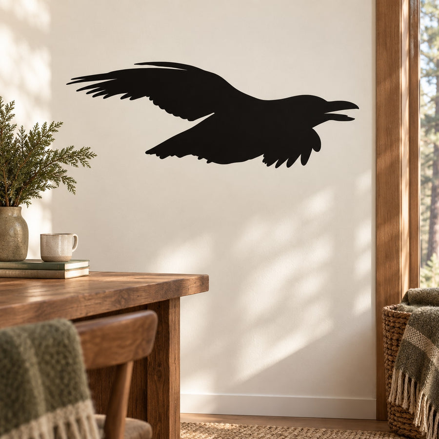 Black soaring raven silhouette wall decal with spread wings, shown in flight