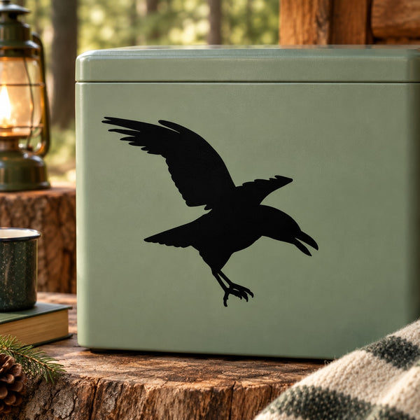 Black crow silhouette decal on light green surface