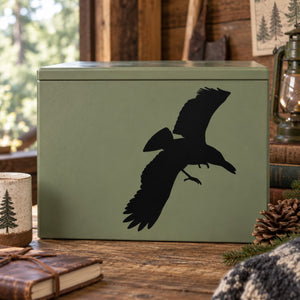 Black hovering crow silhouette decal on sage green gift box