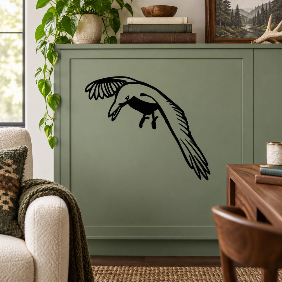 Black crow observing decal on light green cabinet panel