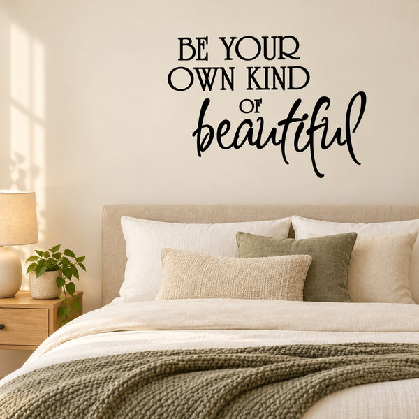 Wall quote decal reading “BE YOUR OWN KIND of beautiful” in black script