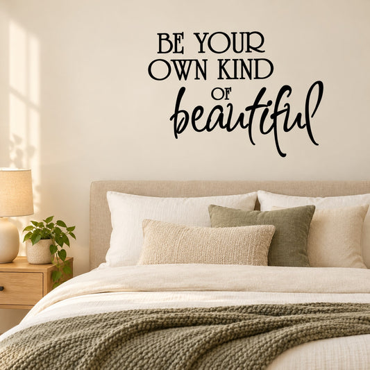 Wall quote decal reading “BE YOUR OWN KIND of beautiful” in black script