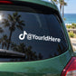 TikTok die-cut decal on car window with @YourdHere text