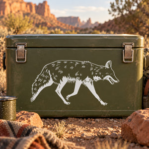 Running coyote decal sticker on dark green surface, white outlined running coyote.