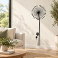 Black dandelion decal sticker set with flower head and thin stem on wall
