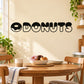 Black donut-themed wall decal spelling DONUTS with donut icons