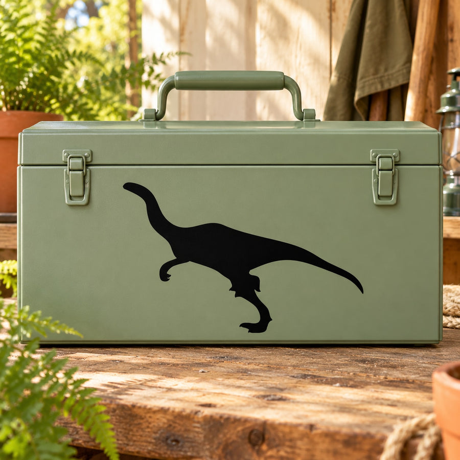 Black dinosaur silhouette decal with long tail on green surface