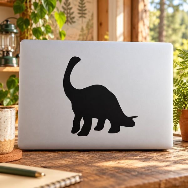 Black brontosaurus silhouette decal on white laptop lid