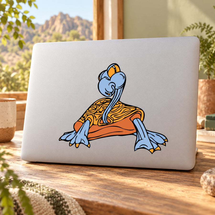 Orange and blue illustrated archelon animal sticker on a light laptop surface