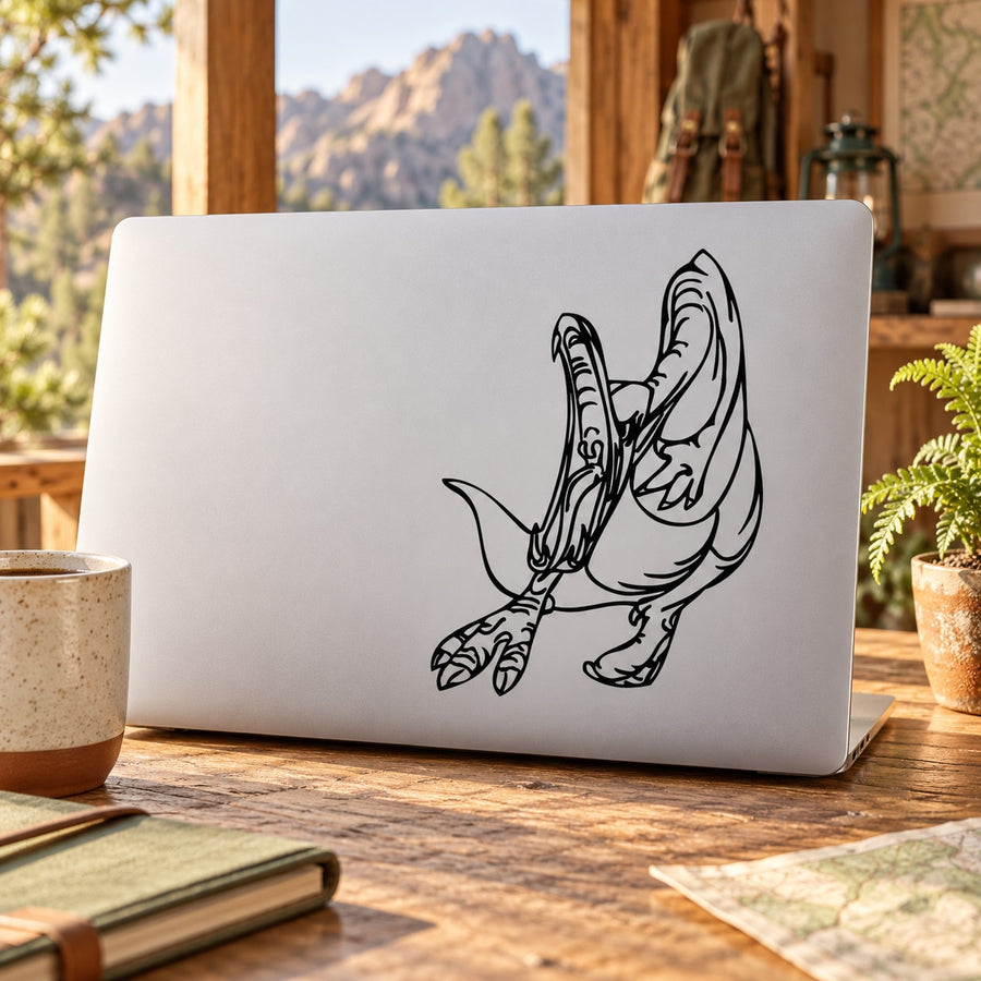 Attacking dinosaur decal with black line-art on white laptop lid