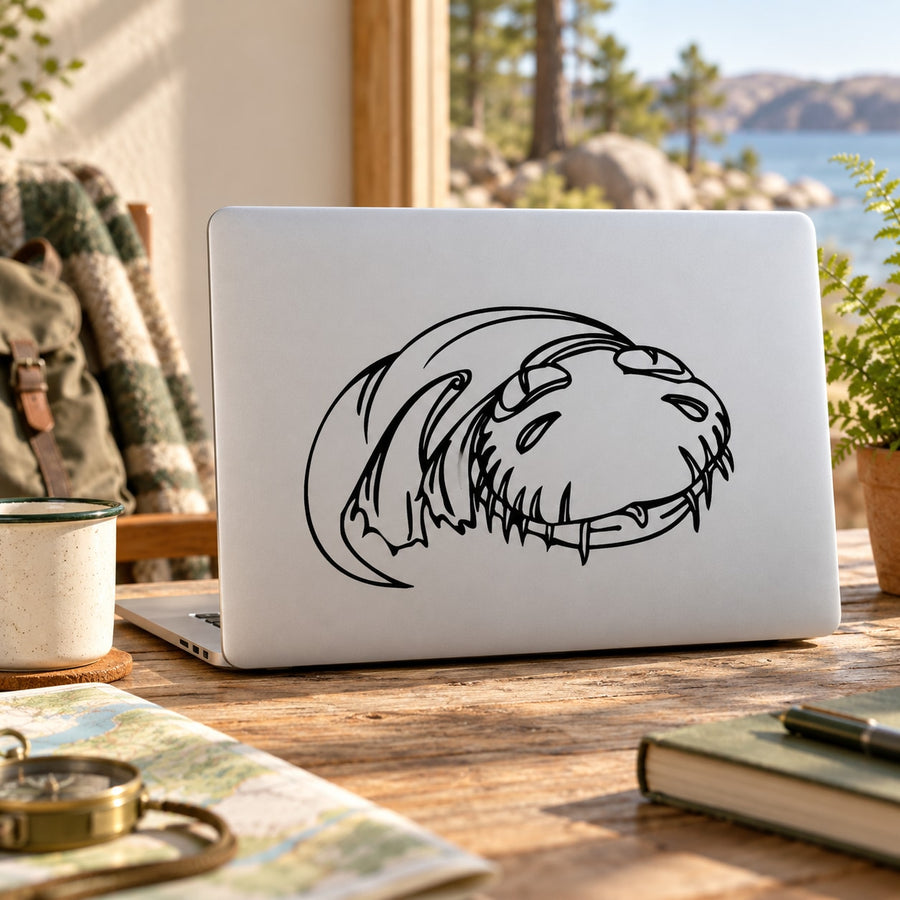 Swimming dinosaur decal sticker in black line art on a white laptop