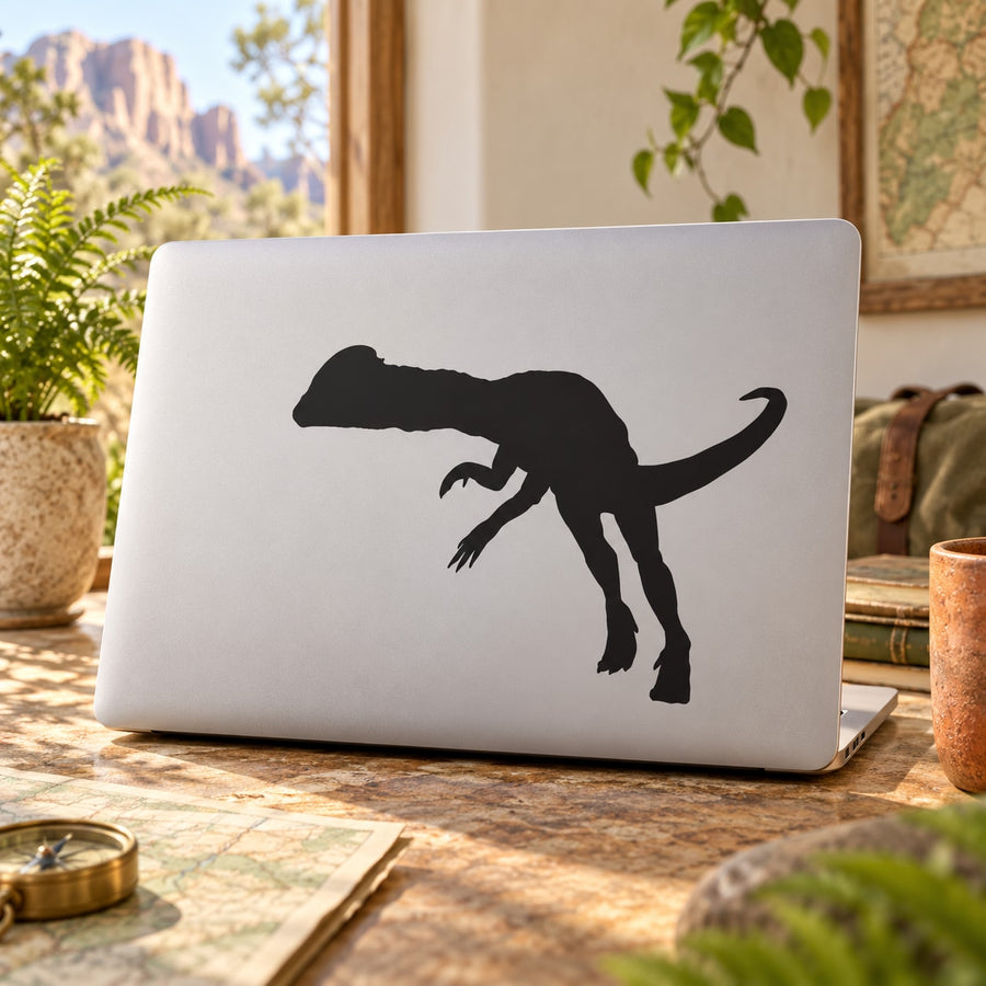 Black Dilophosaurus dinosaur decal silhouette on white laptop lid