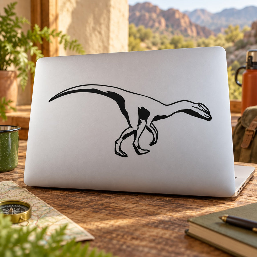 Black Dilophosaurus decal of crouching dinosaur on light surface