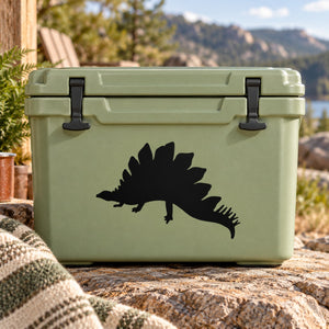 Basking stegosaurus decal, black dinosaur silhouette on light green surface
