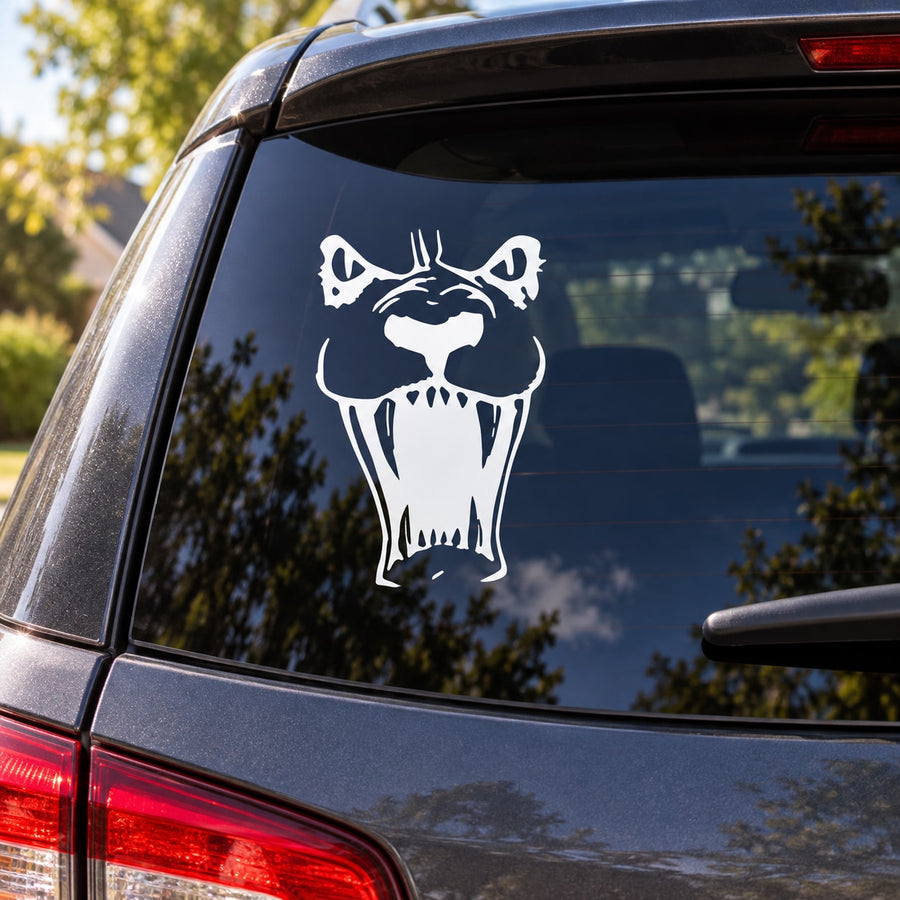 Lion face decal in white on car rear window, bold roaring expression