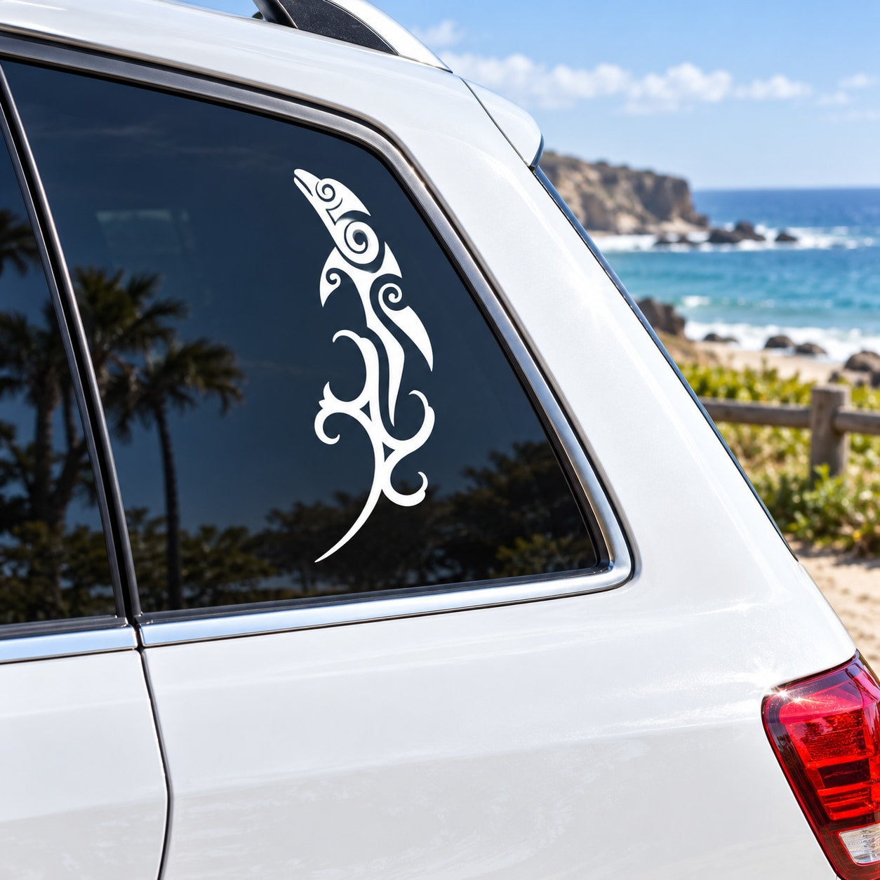 White tribal dolphin splash decal on car window glass with swirling design