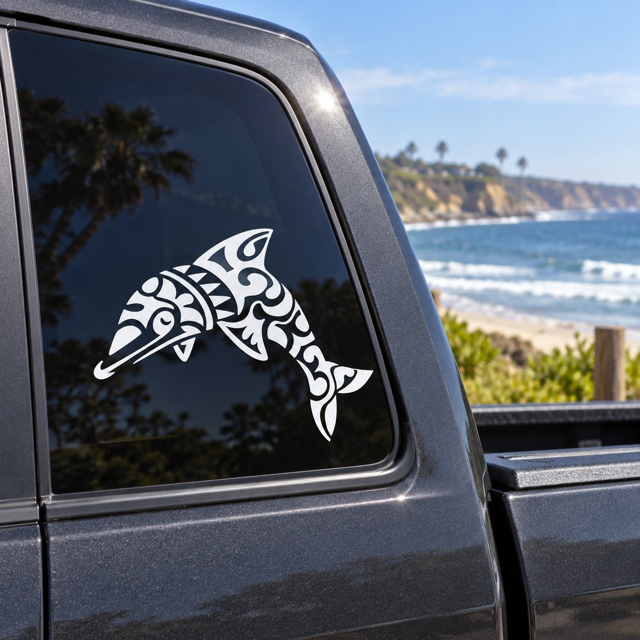 Black and white tribal dolphin decal on car side window
