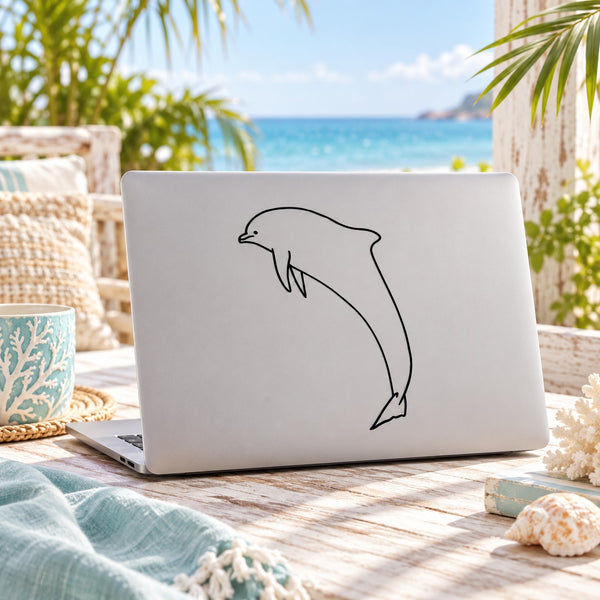 Dolphin line-art decal sticker on a light-colored laptop cover