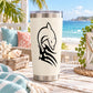 White tumbler with black dolphin decal in mid-jump