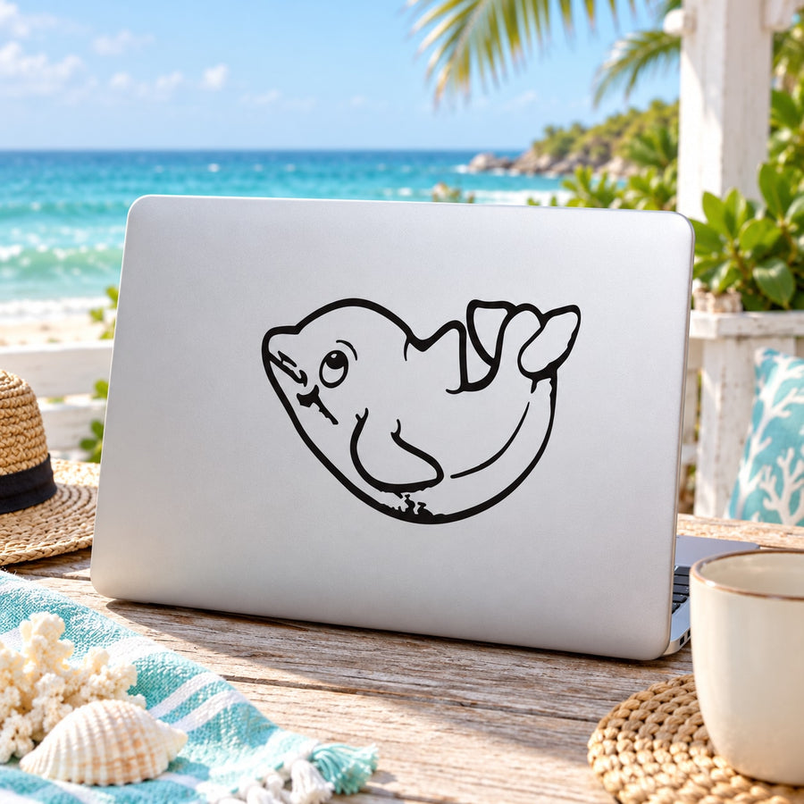 Dolphin decal with cute cartoon line-art design in black on a light laptop lid